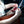 Load image into Gallery viewer, A close up photograph of a girls hands opening an EPIC Chicken Sriracha Bar.